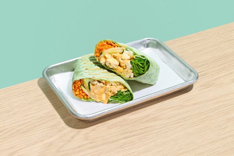 Hot Chix wrap featuring grilled chicken breast, spinach, cucumber, carrots, and aged cheddar cheese with buffalo ranch dressing.