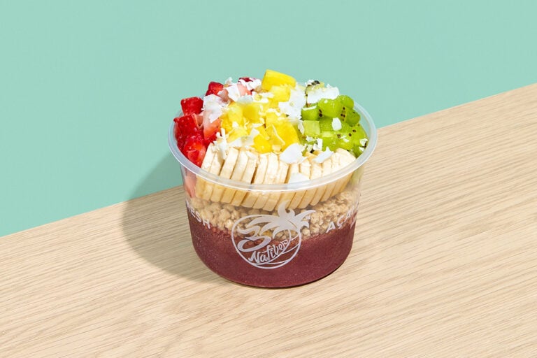 Chronic acai bowl with granola, banana, strawberry, kiwi, pineapple, coconut, and honey