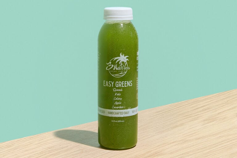Easy Greens cold-pressed juice with apple, cucumber, celery, kale, and spinach in a clear bottle.