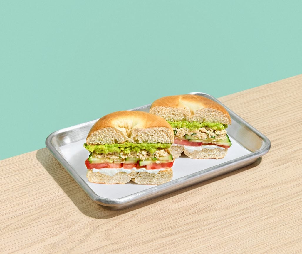 Bagel sandwich with avocado and tomato on a tray