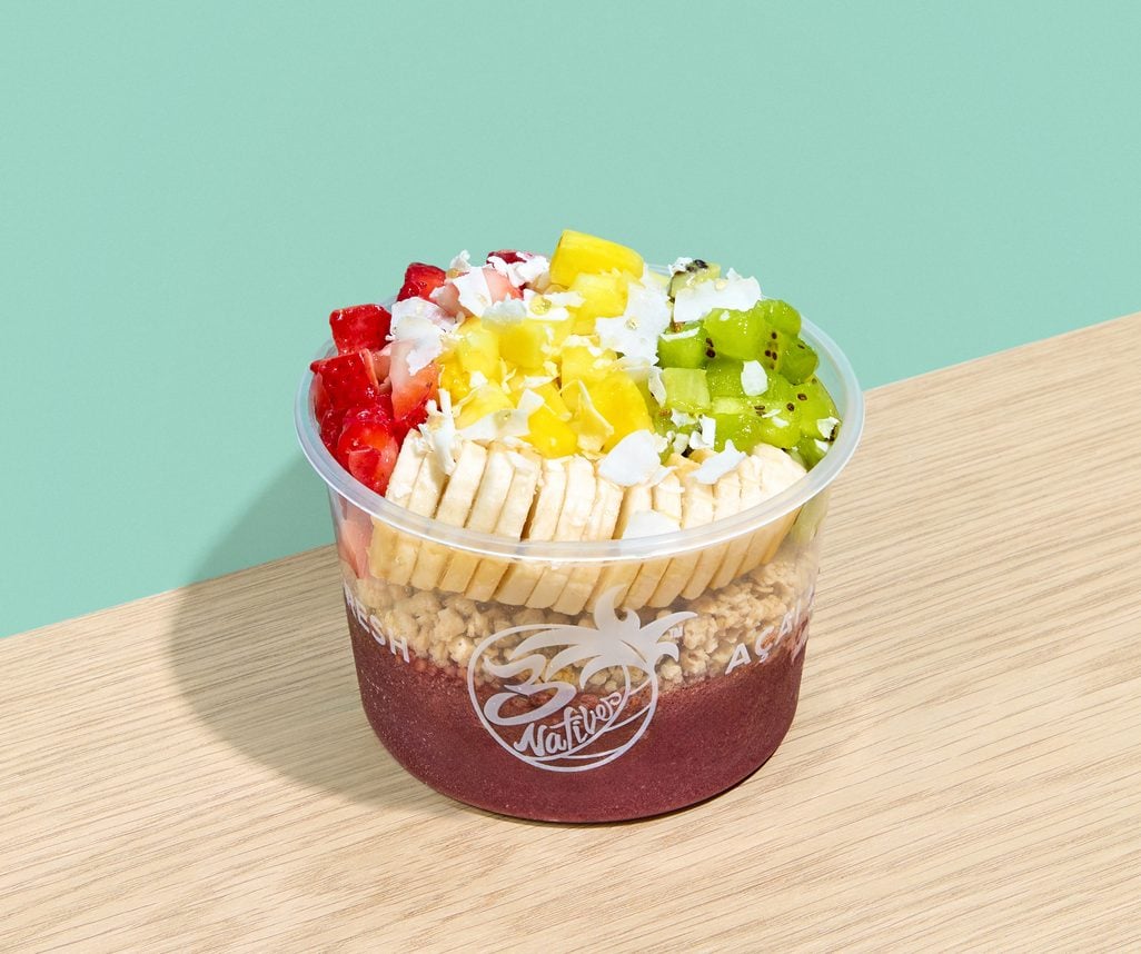 Acai bowl topped with banana, strawberries, mango, coconut and kiwi
